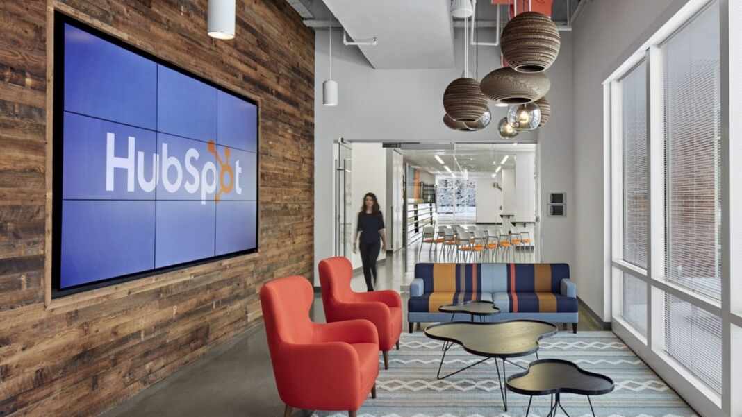 Oficinas de HubSpot con el logo de la empresa en pantalla